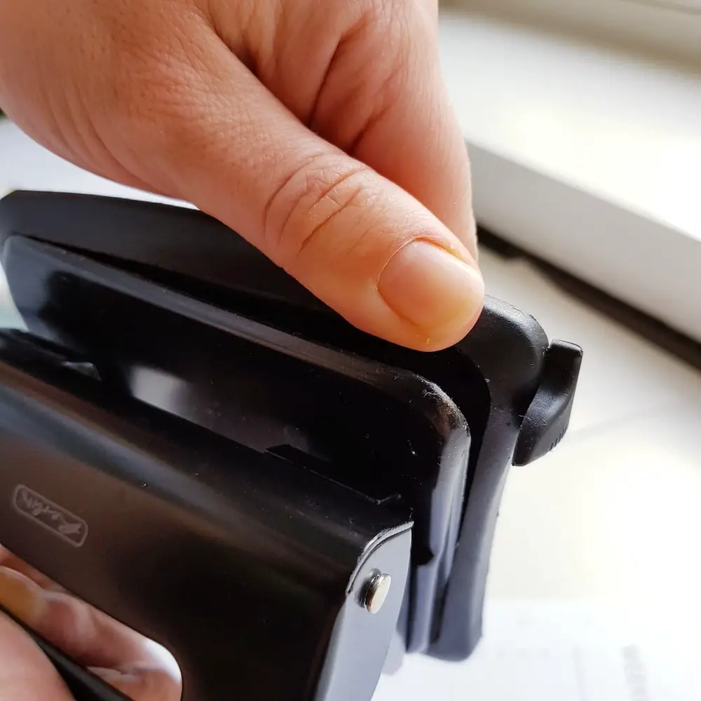 Remove the bottom catch tray from the hole puncher